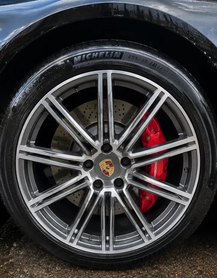 Clean Porsche wheel with red calipers after a Detail Pals wheel cleaning