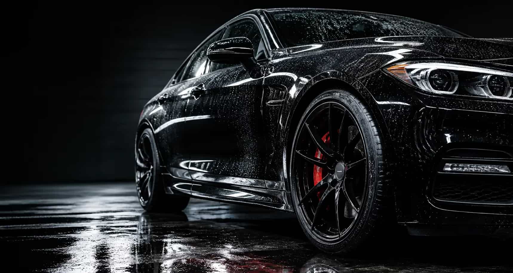Freshly detailed black vehicle with water beads